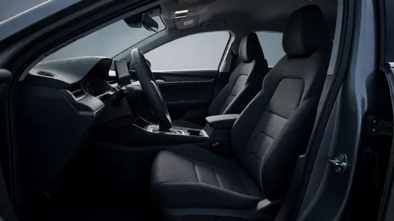 Clean, empty interior of a modern rental car with dark upholstery.