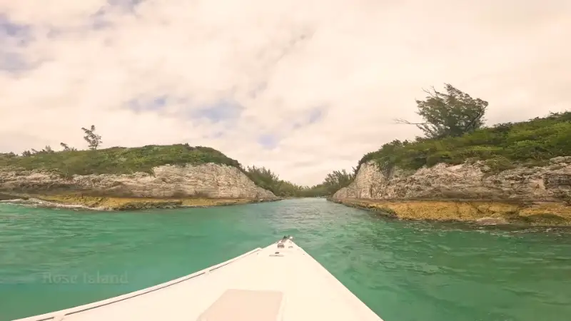 Boat entering a channel between rocky islands at Rose Island
